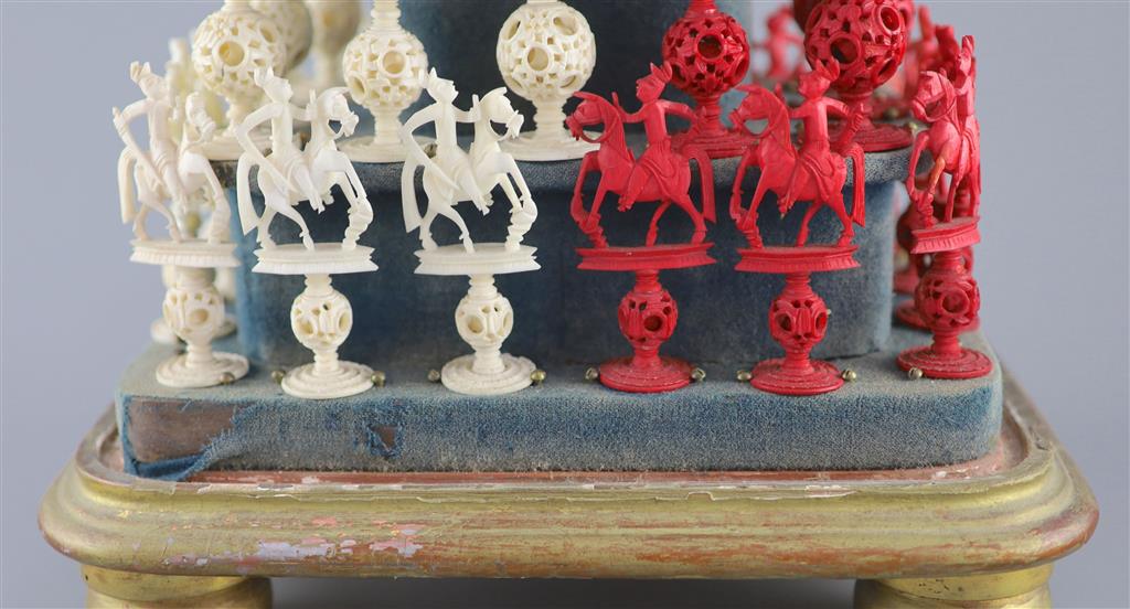 A set of 19th century Cantonese carved and red stained ivory chess pieces under dome, white king 20cm high